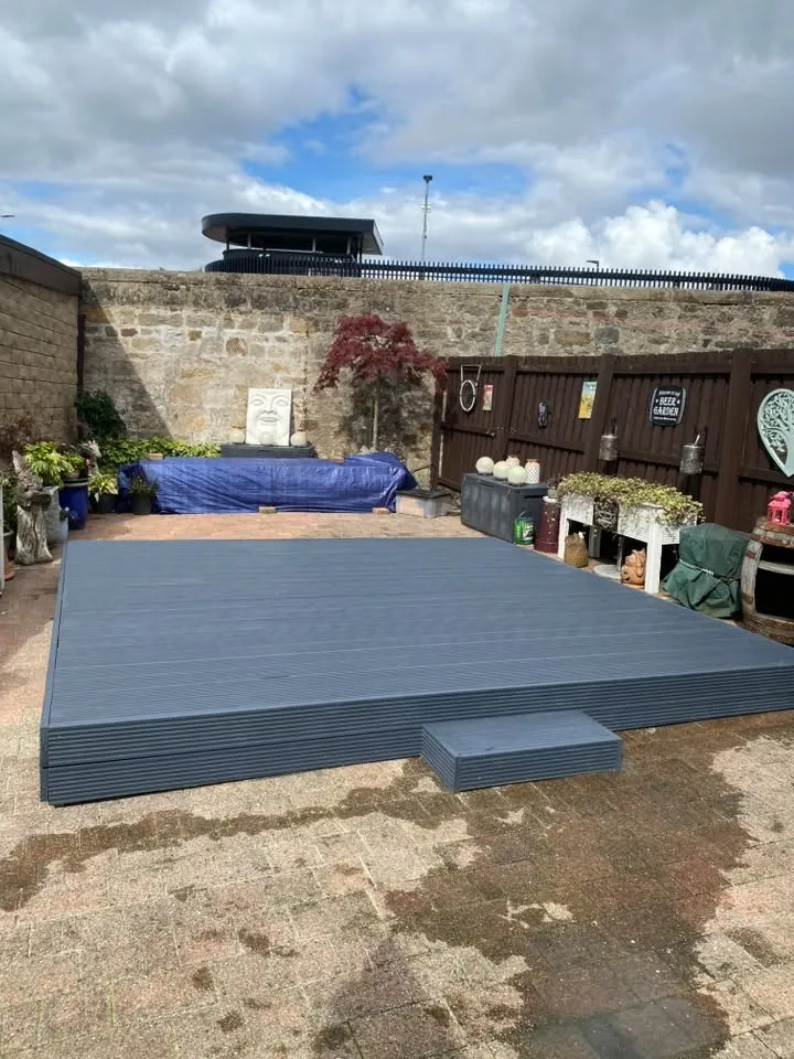 Grey composite decking platform with a matching step