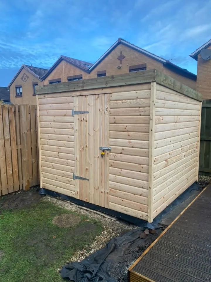 Front view of a pent-roof timber garden building with double doors