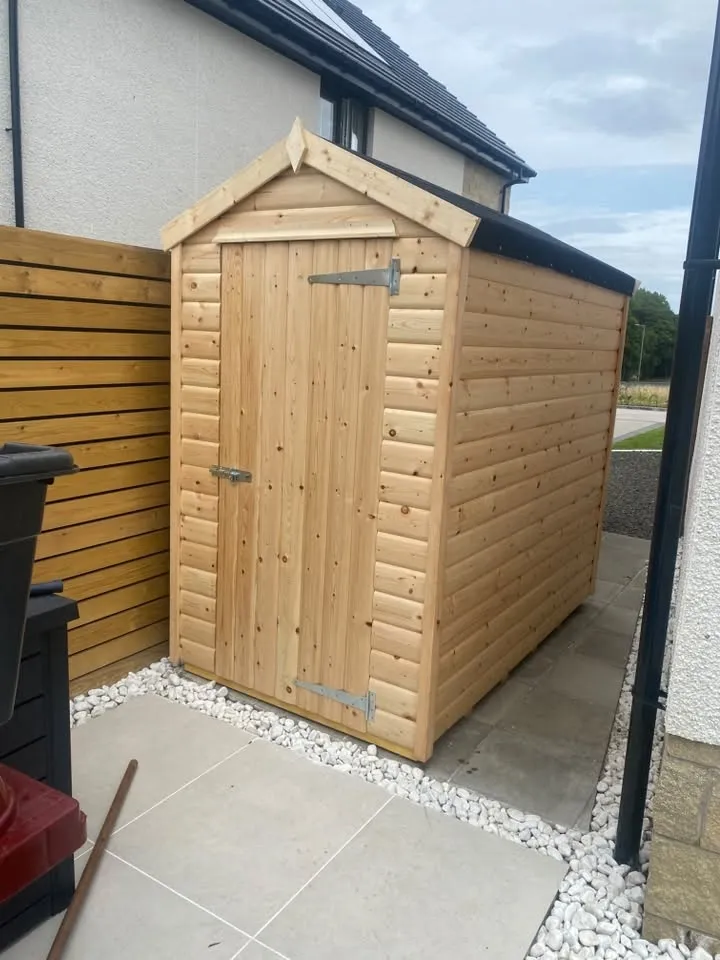 Compact apex timber garden shed on a paved base