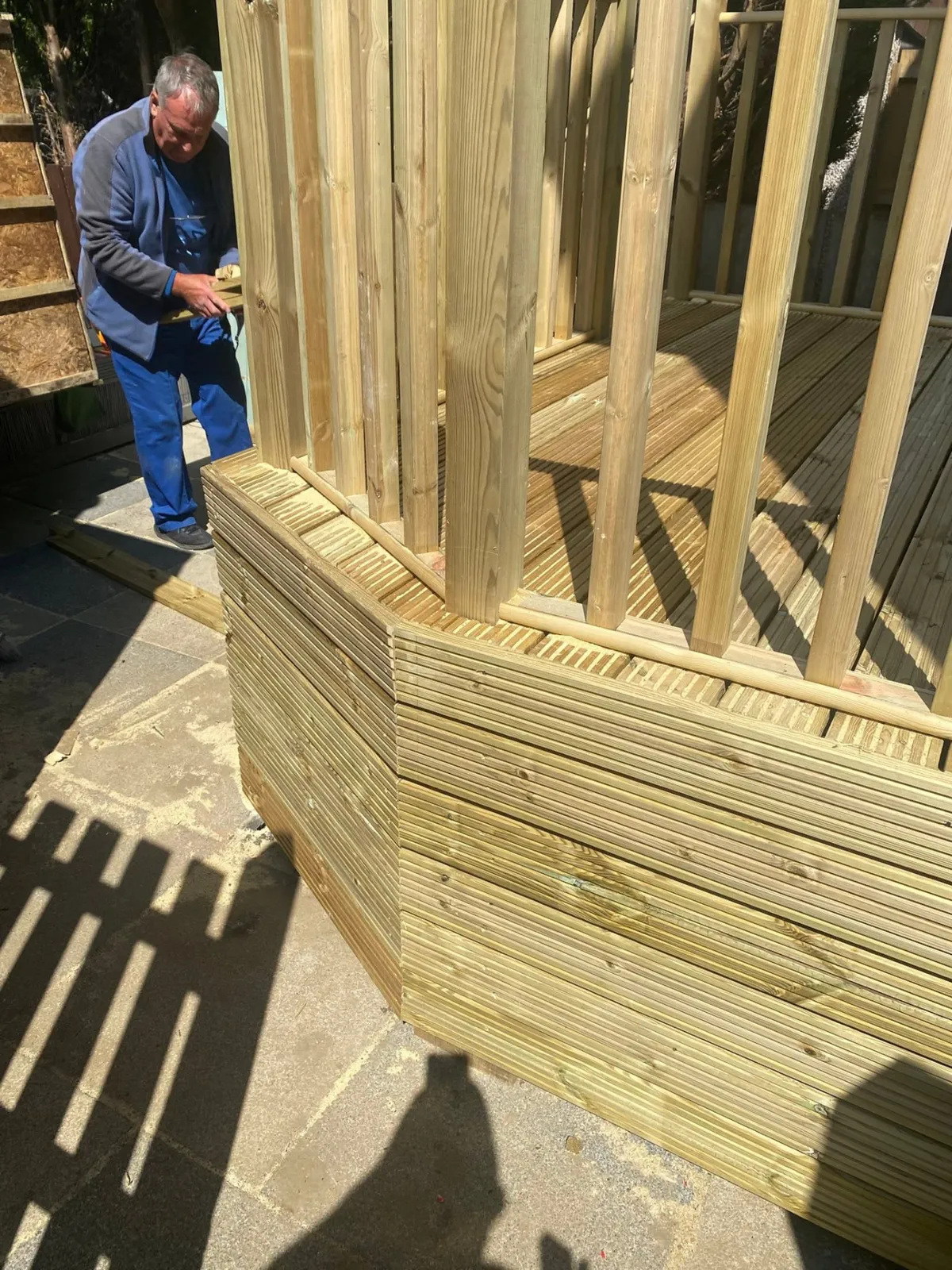 William building a timber deck and balustrade