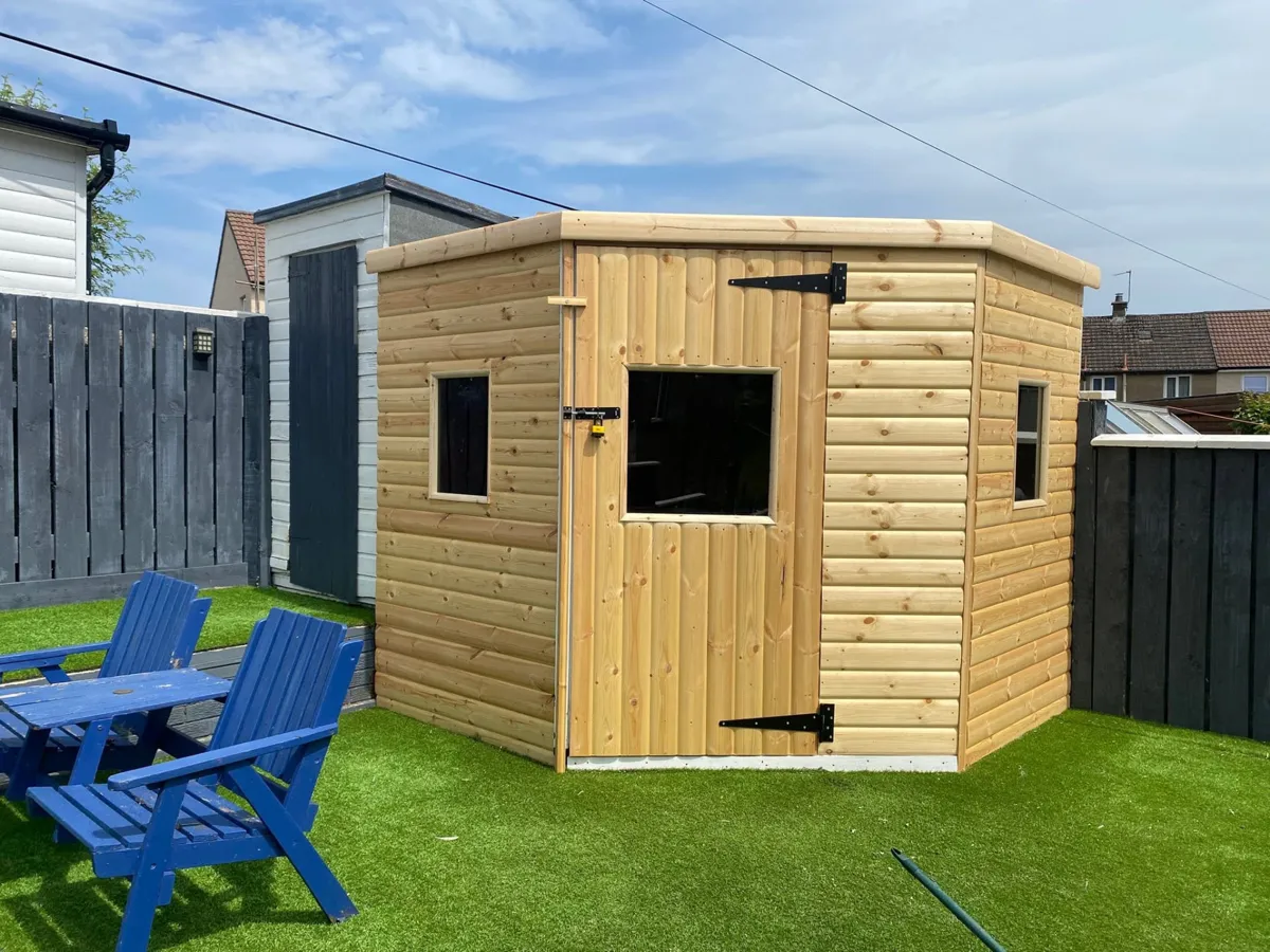 Finished timber summerhouse in a completed garden with lawn and seating
